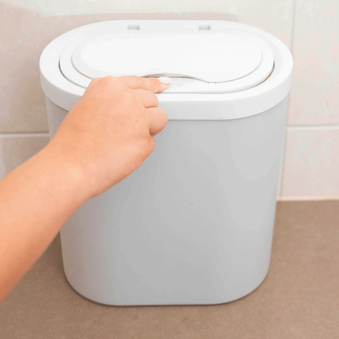 opening the Evelaniq lower bin compartment by pushing the top lid gently